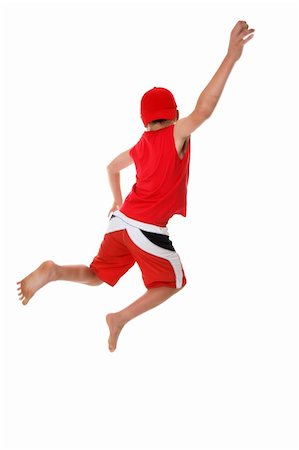 Boy jumps hand raised  in the air.  Jump for joy, leap of faith, etc, fitness, fun or concept.  There is a little bit of  motion in the arm and feet at full size.. Stockbilder - Microstock & Abonnement, Bildnummer: 400-03963007