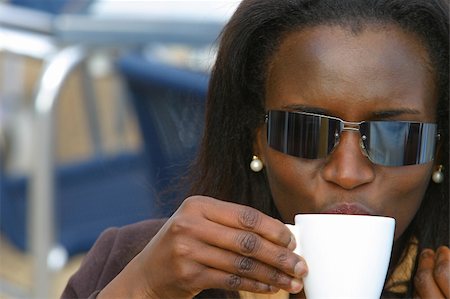 A young African American woman drinking coffee Stock Photo - Budget Royalty-Free & Subscription, Code: 400-03963944