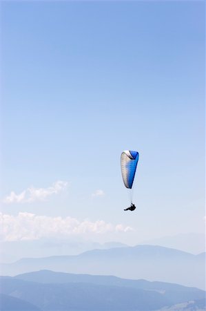 Paraglider soaring over the landscape of the Dolomites - Italy Stock Photo - Budget Royalty-Free & Subscription, Code: 400-03963953