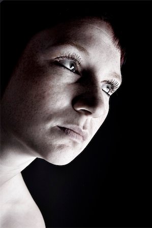 simsearch:400-05041629,k - Studio portrait of a young woman with short hair looking mysterious Fotografie stock - Microstock e Abbonamento, Codice: 400-03974280