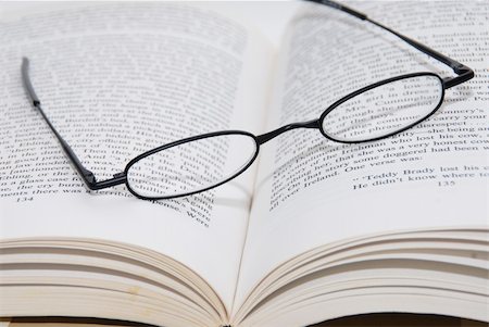 strikerx98 (artist) - A pair of black framed reading glasses resing on a book. Stock Photo - Budget Royalty-Free & Subscription, Code: 400-03974514