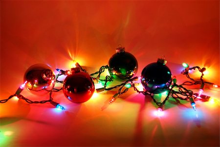 strikerx98 (artist) - A string of Christmas Lights brightens the area around a few ornaments. Stock Photo - Budget Royalty-Free & Subscription, Code: 400-03974516