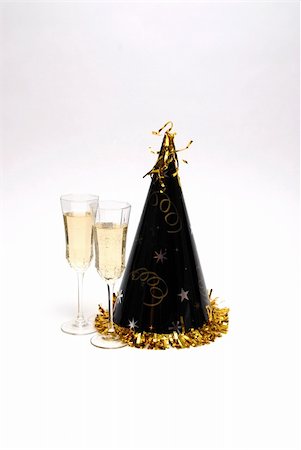 simsearch:400-06064766,k - A New Years celebration complete with party hat and champagne. Stockbilder - Microstock & Abonnement, Bildnummer: 400-03974520