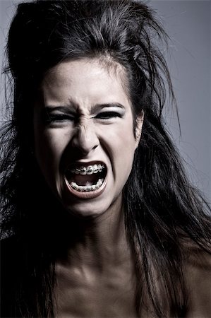 Studio portrait of an asian mixed raced teenager screaming out loud Stock Photo - Budget Royalty-Free & Subscription, Code: 400-03974715