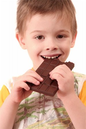 The boy eats a greater chocolate Stockbilder - Microstock & Abonnement, Bildnummer: 400-03975211
