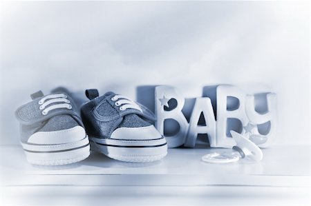 simsearch:400-04939110,k - Little baby denim running shoes with pacifier on shelf Photographie de stock - Aubaine LD & Abonnement, Code: 400-03975826