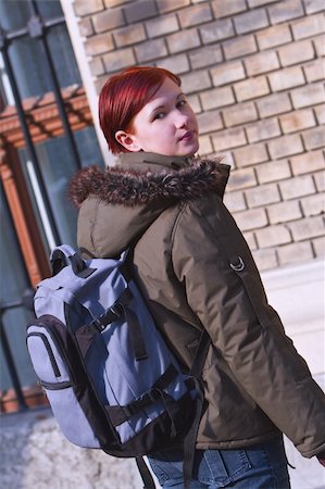 Image of a redheaded girl student with a backpack in front of the University building.Shot with Canon 70-200mm f/2.8L IS USM Stock Photo - Budget Royalty-Free & Subscription, Code: 400-03978089