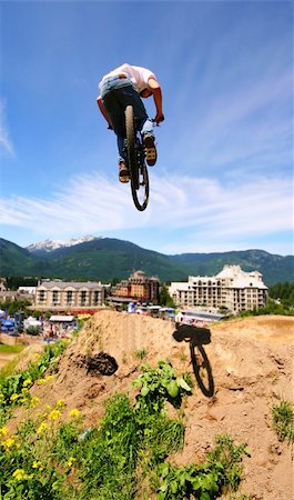 A mountainbiker floats through the air in Whistler, BC. Stock Photo - Budget Royalty-Free & Subscription, Code: 400-03978153