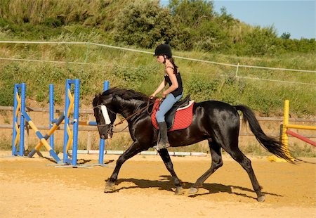 simsearch:400-04256024,k - young teenager and her black horse in training of jumping competition Stock Photo - Budget Royalty-Free & Subscription, Code: 400-03978275