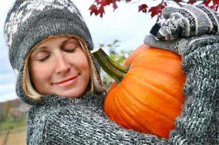 Attractive young woman holding a big orange pummkin Stock Photo - Budget Royalty-Free & Subscription, Code: 400-03979047