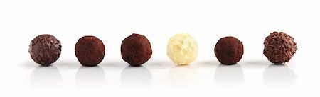 Row of assorted chocolate truffles on white background Stock Photo - Budget Royalty-Free & Subscription, Code: 400-03979378