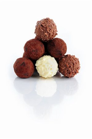 Pyramid of assorted chocolate truffles on white background with reflection Stock Photo - Budget Royalty-Free & Subscription, Code: 400-03979379