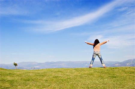 Woman standing on grass field, with arms wide open. Stock Photo - Budget Royalty-Free & Subscription, Code: 400-03970398