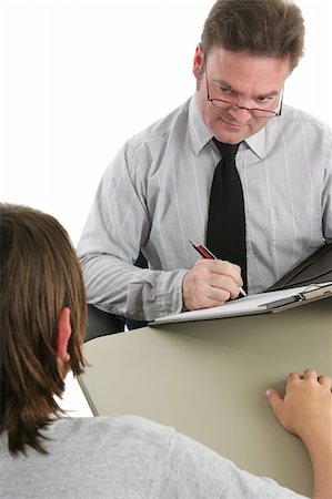 A guidance counselor taking a case history of a student and looking skeptical. Stock Photo - Budget Royalty-Free & Subscription, Code: 400-03970463