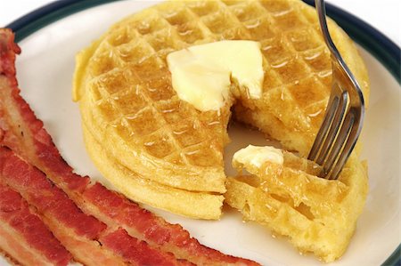 sweet and salty - A closeup of waffles dripping with syrup and butter, with bacon strips on the side. Stock Photo - Budget Royalty-Free & Subscription, Code: 400-03970901