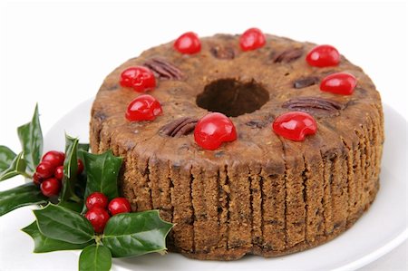 A beautiful Christmas fruitcake garnished with cherries and holly berries.  White background. Stock Photo - Budget Royalty-Free & Subscription, Code: 400-03970984