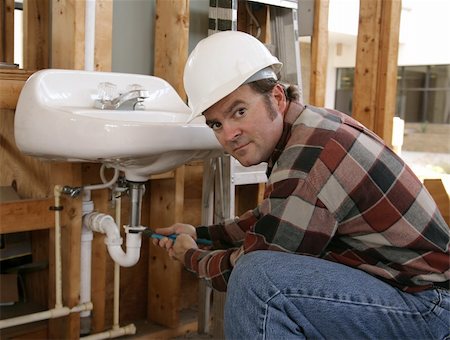 simsearch:400-08784548,k - A plumber installing fixtures in a construction site. Foto de stock - Super Valor sin royalties y Suscripción, Código: 400-03971104