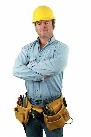 A handsome construction worker wearing a hard hat and tool belt and looking serious. Stock Photo - Budget Royalty-Free & Subscription, Code: 400-03971151