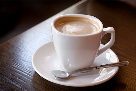 simsearch:622-07841278,k - Cup of coffee (focus on the froth surface) on the cafe table. Shallow depth of field. Foto de stock - Super Valor sin royalties y Suscripción, Código: 400-03971298
