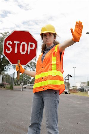 simsearch:614-06813293,k - A female construction worker stopping traffic. Foto de stock - Royalty-Free Super Valor e Assinatura, Número: 400-03971310