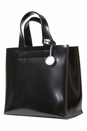 simsearch:400-03964192,k - Black leather bag with a metal medallion Photographie de stock - Aubaine LD & Abonnement, Code: 400-03971626