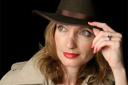 A beautiful woman in a trenchcoat and fedora hat, lost in thought. Photographie de stock - Aubaine LD & Abonnement, Code: 400-03971659