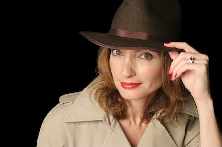 A beautiful, sexy woman dressed as a spy in a trenchcoat and fedora hat. Foto de stock - Super Valor sin royalties y Suscripción, Código: 400-03971650