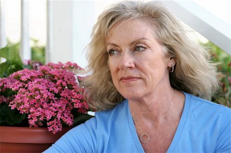 simsearch:400-05020346,k - A beautiful mature woman sitting on her front porch thinking with a faraway look in her eyes. Stock Photo - Budget Royalty-Free & Subscription, Code: 400-03972226