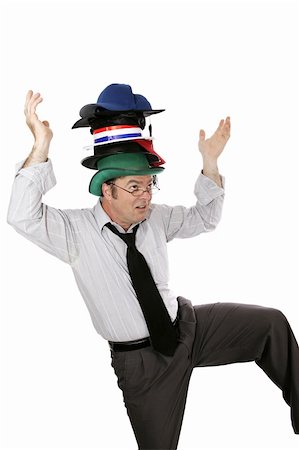 exasperated teacher - Overwhelmed white collar worker wearing too many hats and balancing on one foot.  Isolated on white. Stock Photo - Budget Royalty-Free & Subscription, Code: 400-03972265