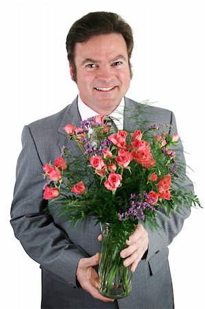 simsearch:400-05294518,k - A handsome businessman holding a bouquet of roses for his wife, girlfriend, or secretary. Fotografie stock - Microstock e Abbonamento, Codice: 400-03972275