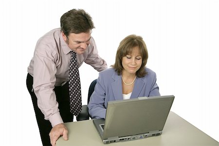 A businessman and woman working together using a laptop.  Isolated on white. Photographie de stock - Aubaine LD & Abonnement, Code: 400-03972361