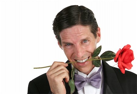 simsearch:400-04171391,k - A handsome romantic young man with a rose in his teeth. Stock Photo - Budget Royalty-Free & Subscription, Code: 400-03972375