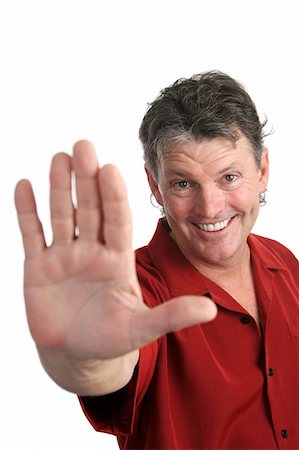 A handsome, casual man holding his hand out in a stop gesture.  Focus on man's face.  Isolated. Stock Photo - Budget Royalty-Free & Subscription, Code: 400-03972378