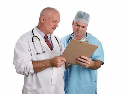 Two doctors confering together on the best treatment course for a patient. Stock Photo - Budget Royalty-Free & Subscription, Code: 400-03972397