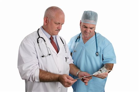 A resident and an intern consult on a patient's medical chart. Stock Photo - Budget Royalty-Free & Subscription, Code: 400-03972401