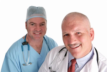 A happy mature doctor and his smiling intern.  Isolated on white. Stock Photo - Budget Royalty-Free & Subscription, Code: 400-03972425