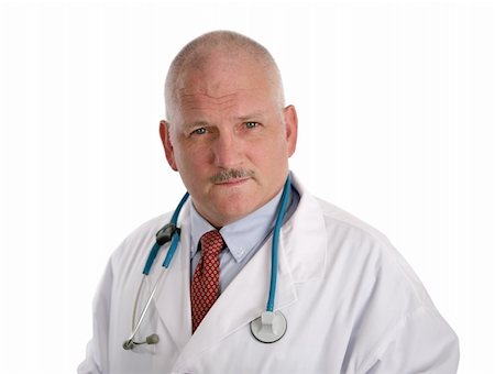 A handsome, mature doctor with a concerned expression, isolated on white. Stock Photo - Budget Royalty-Free & Subscription, Code: 400-03972448