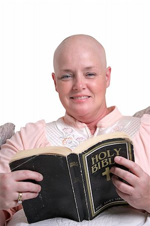 A medical patient smiling as she reads the bible. Stock Photo - Budget Royalty-Free & Subscription, Code: 400-03972461