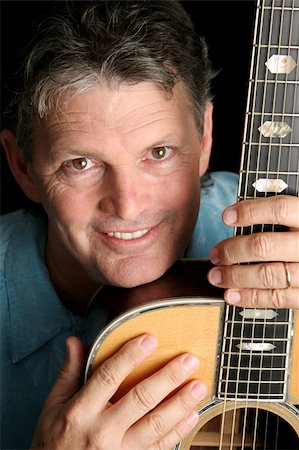 simsearch:400-03972483,k - A handsome, mature musician posing with his guitar. Stock Photo - Budget Royalty-Free & Subscription, Code: 400-03972476
