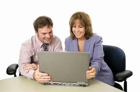 A male-female business team with a laptop, happy over their success.  Isolated. Stock Photo - Budget Royalty-Free & Subscription, Code: 400-03972488