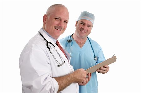 A horizontal view of two handsome, smiling doctors holding a patient's chart.  Isolated. (focus on doctor in foreground) Stock Photo - Budget Royalty-Free & Subscription, Code: 400-03972482