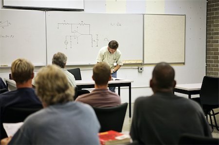 An adult education class in electricity.  Focus on the electrical circuit diagram on the board. Stock Photo - Budget Royalty-Free & Subscription, Code: 400-03972756