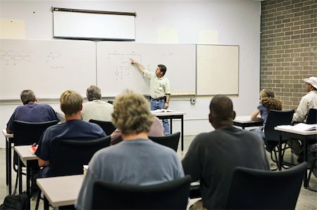 An adult education teacher pointing to an electrical circuit on the board.  Focus on the diagram of the circuit. Stock Photo - Budget Royalty-Free & Subscription, Code: 400-03972757