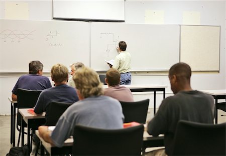 An adult education teacher in front of his class, drawing a diagram on the board.  Focus on teacher and diagrams. Stock Photo - Budget Royalty-Free & Subscription, Code: 400-03972758