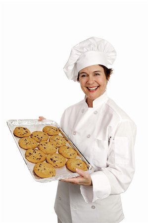 Three quarter view of a happy, smiling bakery chef holding a tray of fresh chocolate chip cookies.  Isolated on white. Stock Photo - Budget Royalty-Free & Subscription, Code: 400-03972770