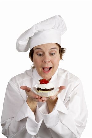 A pastry chef excited about a strawberry cheesecake tart she has just made.  Isolated on white. Foto de stock - Super Valor sin royalties y Suscripción, Código: 400-03972772