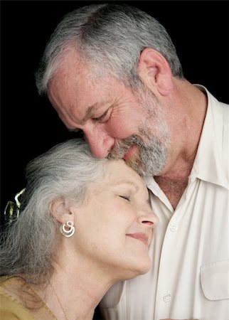 simsearch:400-04109826,k - A beautiful middle aged couple tenderly embracing eachother.  They are very much in love.  Black background. Fotografie stock - Microstock e Abbonamento, Codice: 400-03972809
