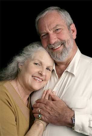 simsearch:400-04109826,k - Portrait of a happy, successful middle aged couple over a black background. Fotografie stock - Microstock e Abbonamento, Codice: 400-03972874