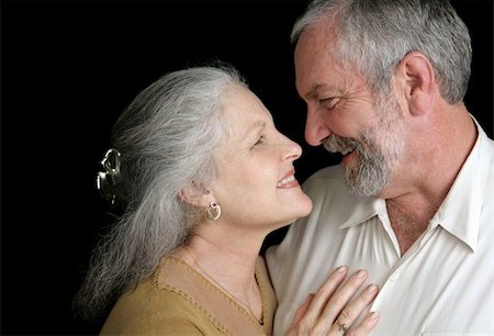 simsearch:400-03972903,k - A good looking mature couple flirting with eachoter.  Black background. Stock Photo - Budget Royalty-Free & Subscription, Code: 400-03972873