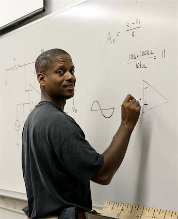 A handsome african-american student at the board doing trigonometry. Stock Photo - Budget Royalty-Free & Subscription, Code: 400-03972904